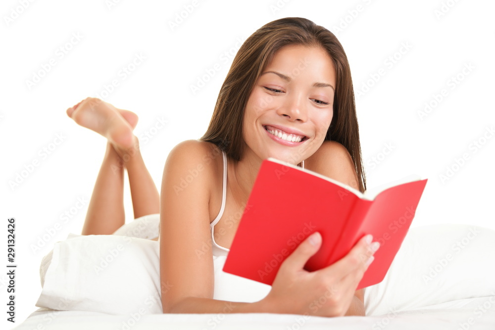 Woman reading book in bed Woman reading book in bed