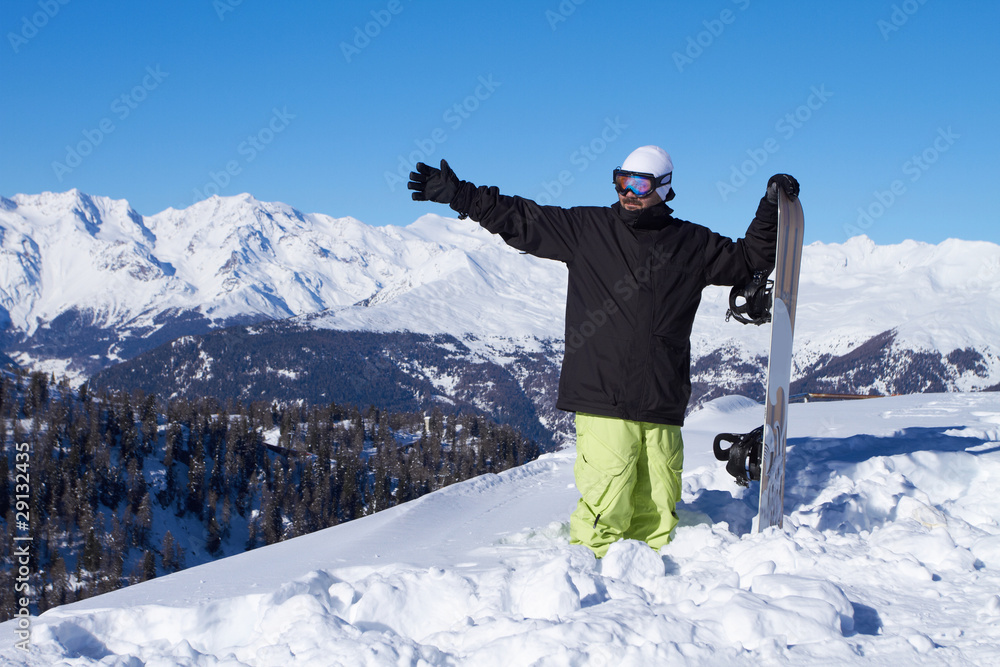 Sporty male snowboarder pointing hand in his right