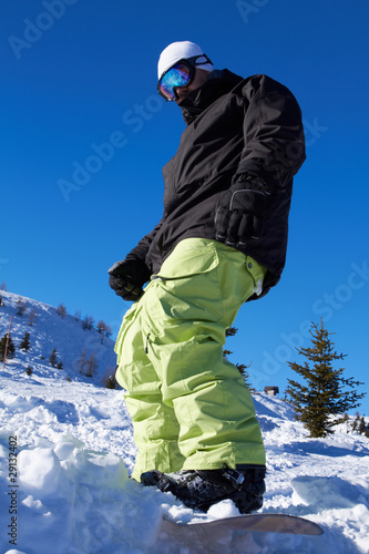 Snowboarder standing on board in Italian Mountains