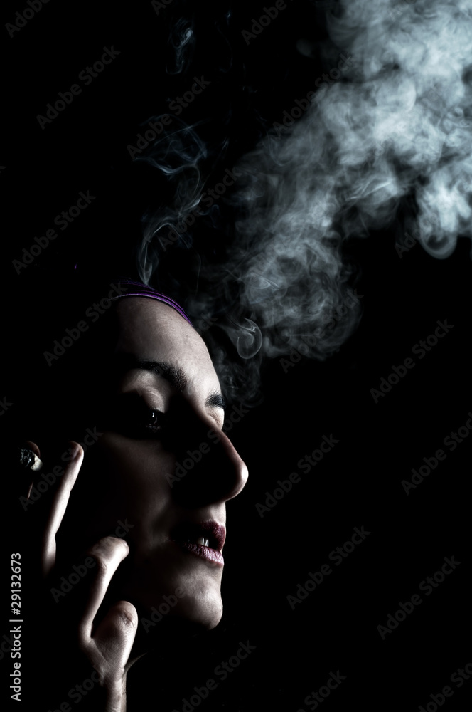 portrait of a girl who smokes on a black background