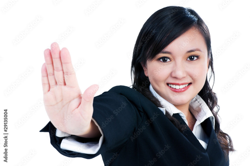 Happy young businesswoman indicating stop sign Happy young businesswoman indicating stop sign