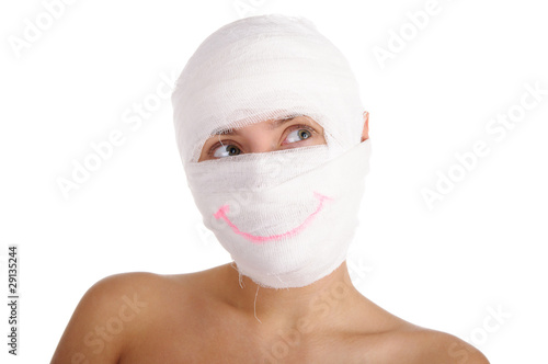Woman with bandaged head with drawn smile