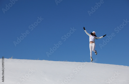 The jumping young girl on snow
