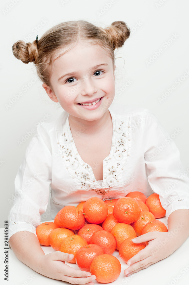Little girl and orange mandarin fruits - healthy food Little girl and orange mandarin fruits - healthy food