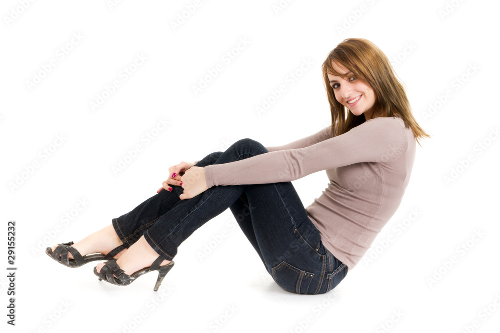 young woman sitting on floor isolated on white young woman sitting on floor isolated on white