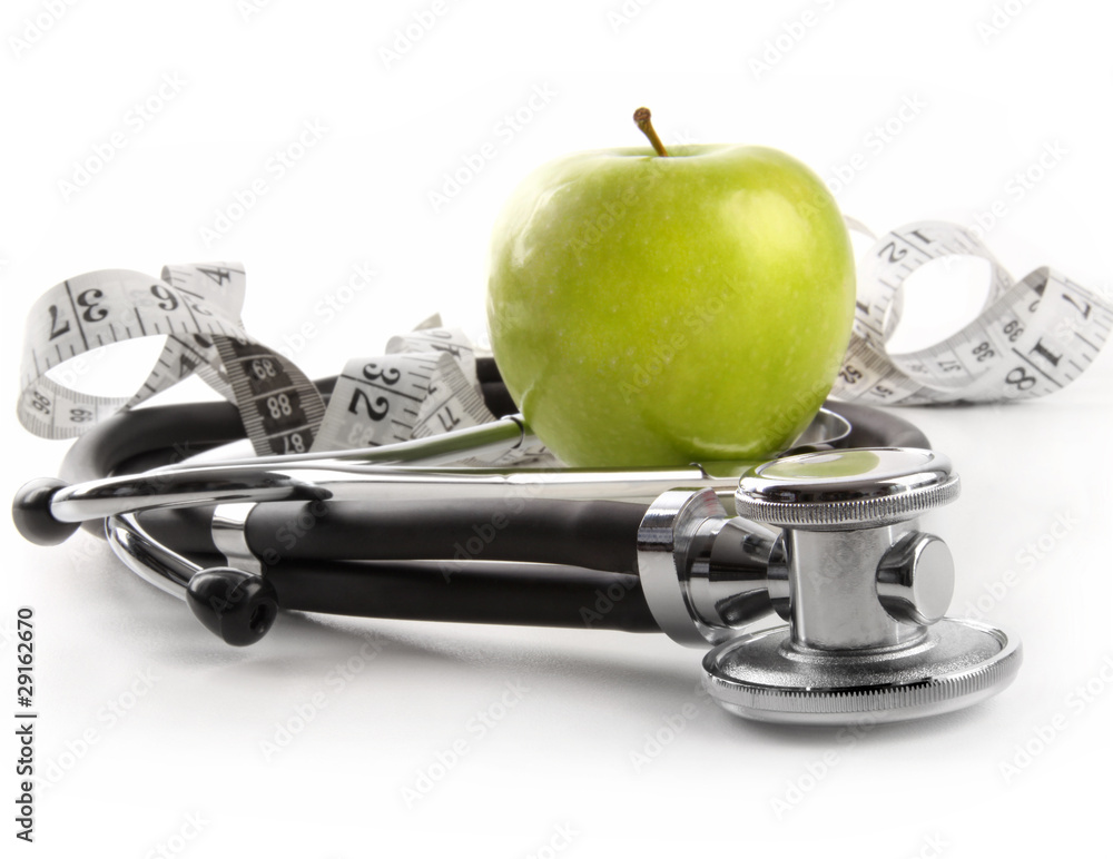 Green apple with stethoscope on white Green apple with stethoscope on white