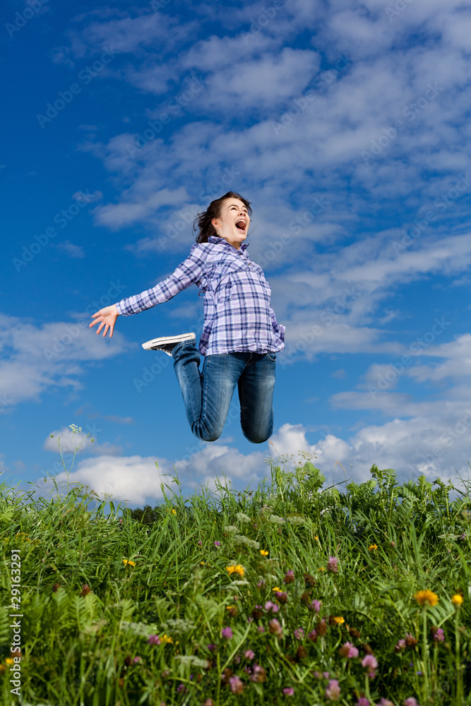 Girl jumping, running against blue sky Girl jumping, running against blue sky