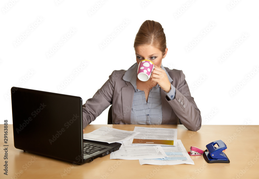 Woman in suit sitting at the desk isolated on white Woman in suit sitting at the desk isolated on white