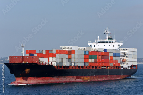 Container ship with load of containers, at sea.