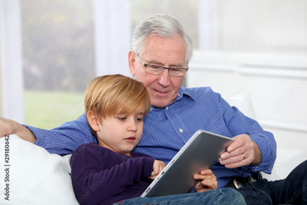 Grandpa with little boy using electronic tablet Grandpa with little boy using electronic tablet