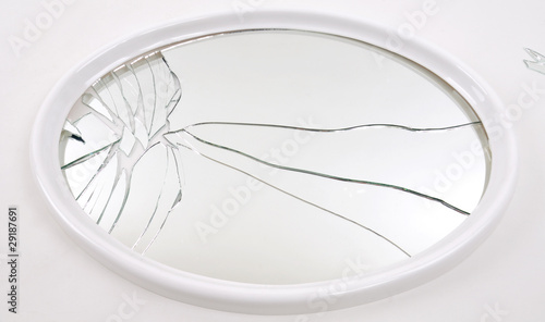 Macro of a shattered mirror isolated on white background.