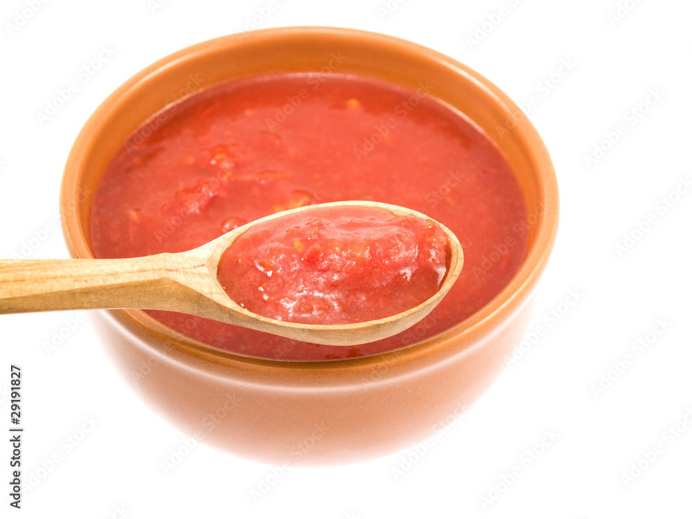 Spoon of sauce near a plate Spoon of sauce near a plate