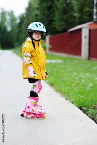 Adorable little girl on pink roller-skates
