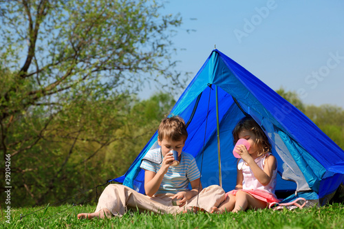 children drinking water in tent