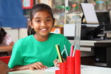 Schoolgirl brilliant smile at her desk in class