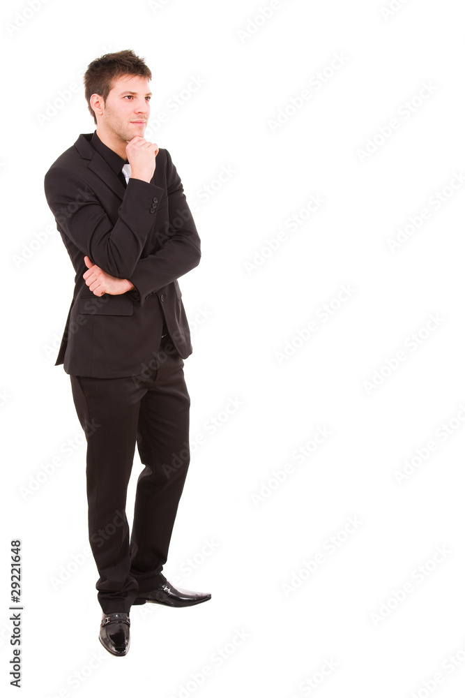 Pensive young business man full body standing against white back Pensive young business man full body standing against white back
