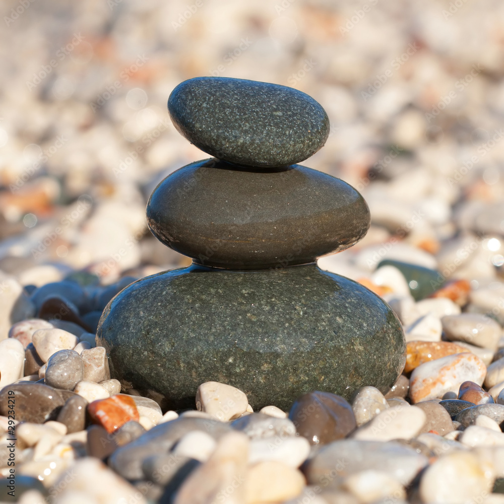Pyramid made with wet pebble stones on the sea beach Pyramid made with wet pebble stones on the sea beach