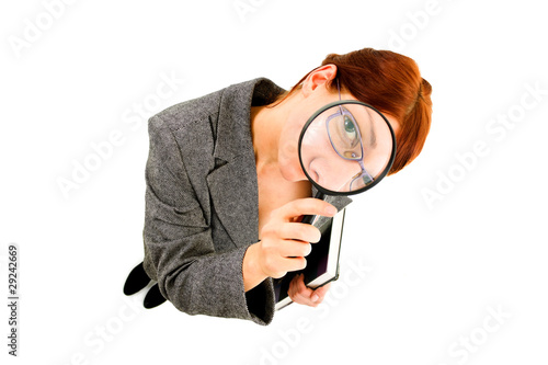 woman looikng into a magnifying glass photo