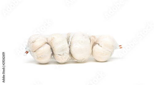 net with garlic on white