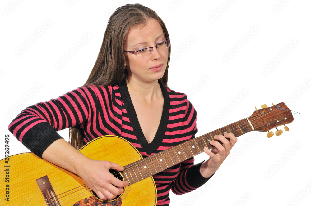 A girl plays a sad tune on the six-string guitar A girl plays a sad tune on the six-string guitar