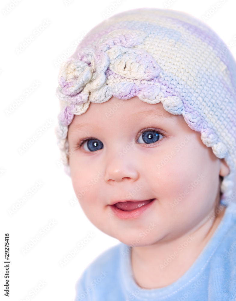 Smiling baby girl showing teeth wearing a hat Smiling baby girl showing teeth wearing a hat