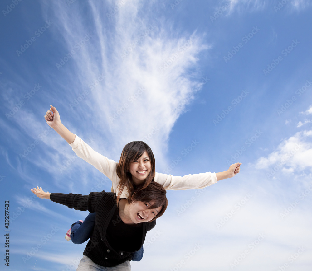 Young Asian Couple smiling under blue sky and cloud. Young Asian Couple smiling under blue sky and cloud.