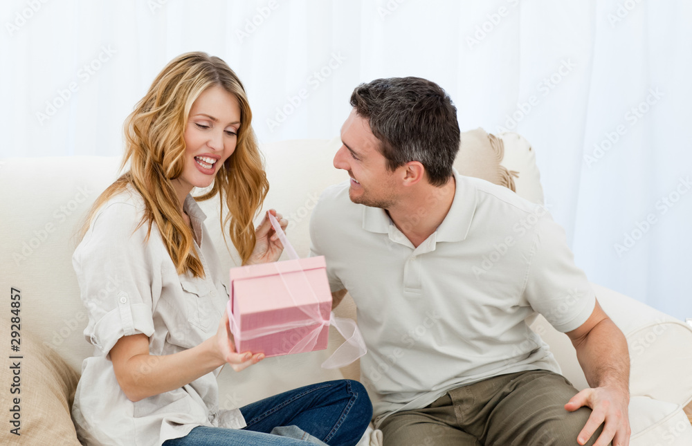 Man offering a gift to his wife Man offering a gift to his wife