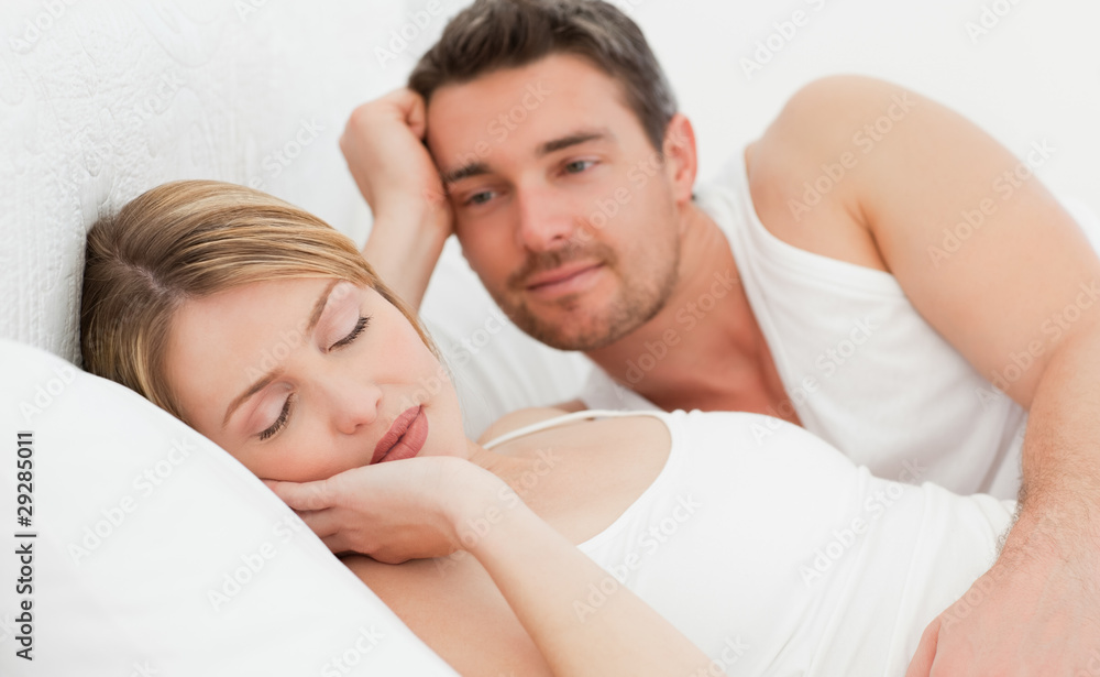Boyfriend looking at his girlfriend who is sleeping Boyfriend looking at his girlfriend who is sleeping