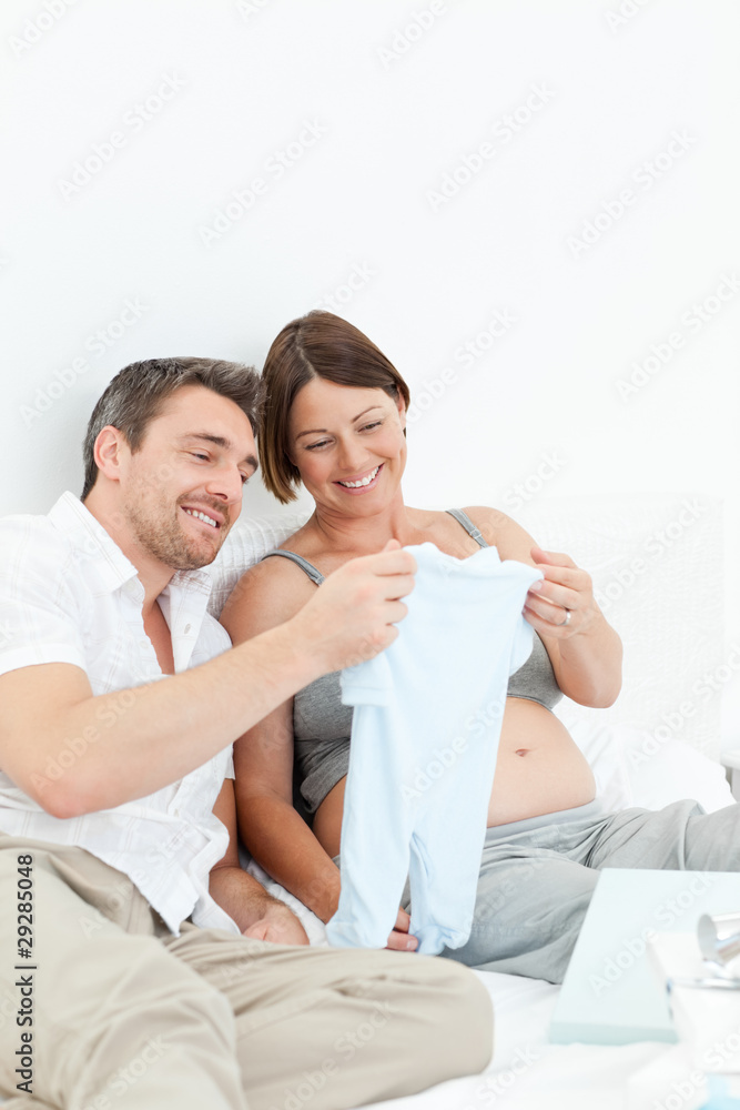 Young futur parents with chlidrens clothes Young futur parents with chlidrens clothes
