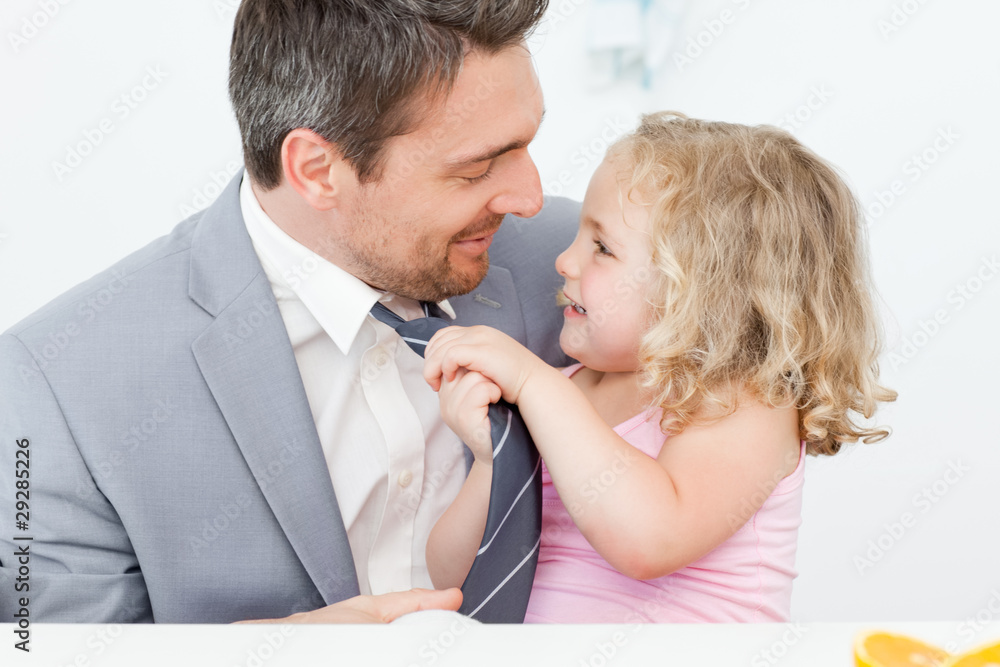 Little girl adjusting the tie of her father Little girl adjusting the tie of her father