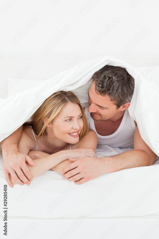 Lovely pair hugging in their bed Lovely pair hugging in their bed