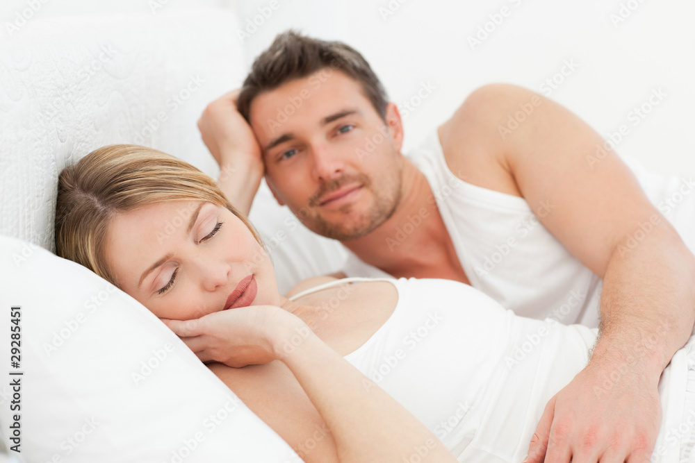 Boyfriend looking at his girlfriend who is sleeping Boyfriend looking at his girlfriend who is sleeping