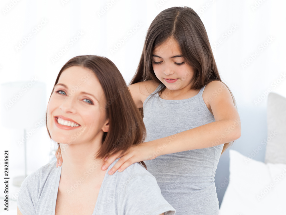 Lovely daughter brushing her woman hairs at home Lovely daughter brushing her woman hairs at home