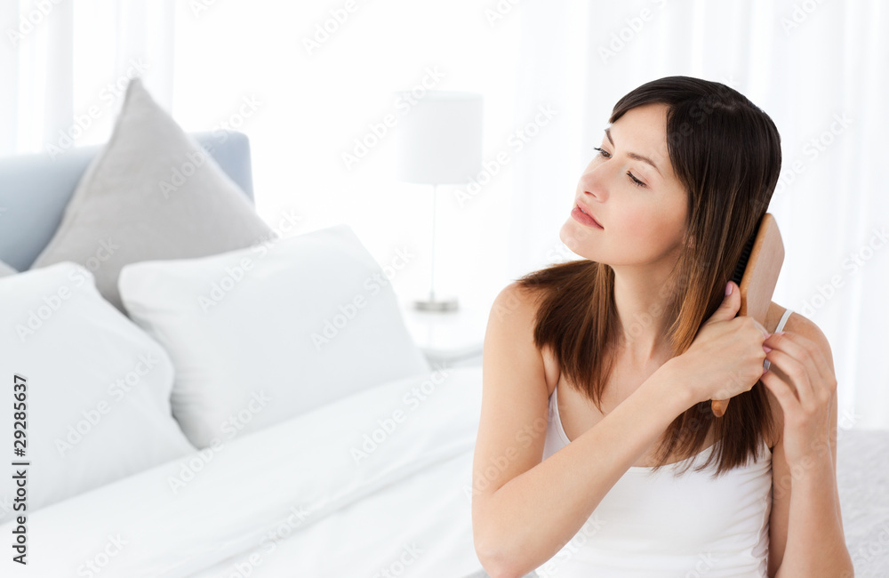 Beautiful woman brushing her hair Beautiful woman brushing her hair