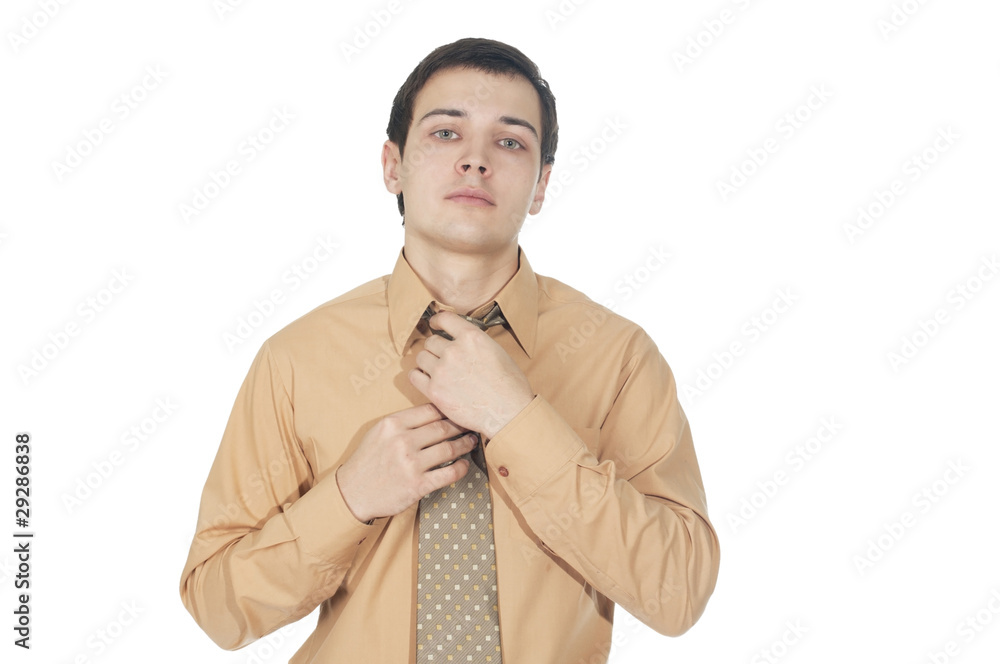 Young businessman corrects tie