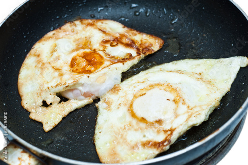 eggs fried in a pan isolated