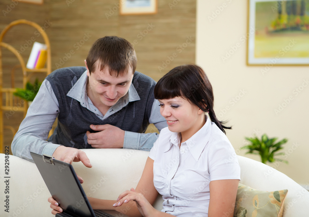 couple with a laptop at home couple with a laptop at home