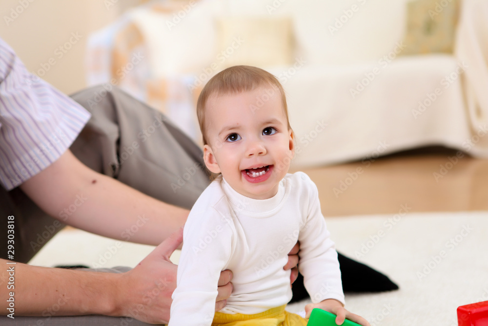 young family at home playing with a baby young family at home playing with a baby
