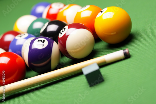 Billiard balls  cue on green table 