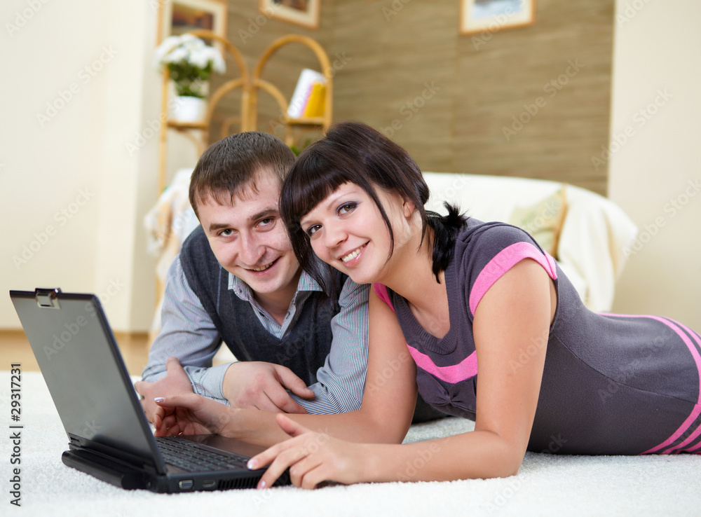 couple with a laptop at home couple with a laptop at home