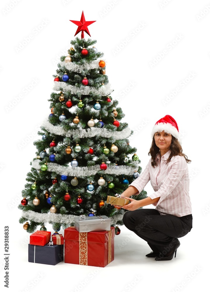 Young woman near christmas tree with presents