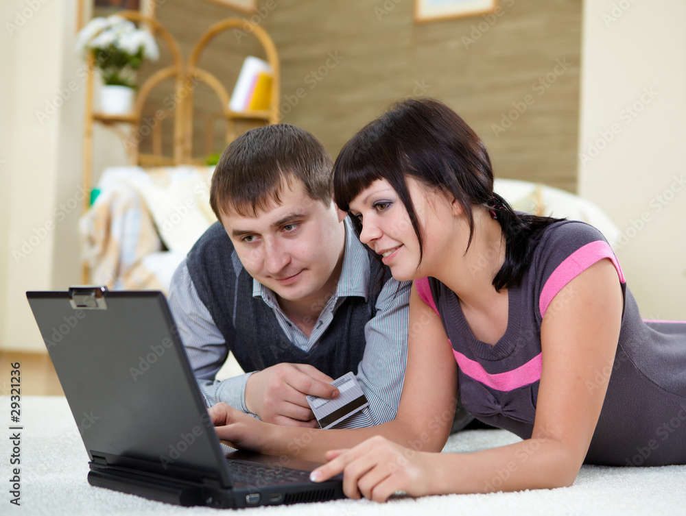 couple with a laptop at home couple with a laptop at home