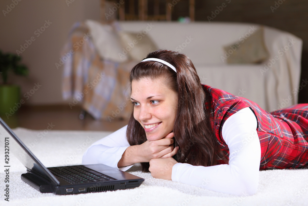 Fototapeta premium a young girl with a lap top at home