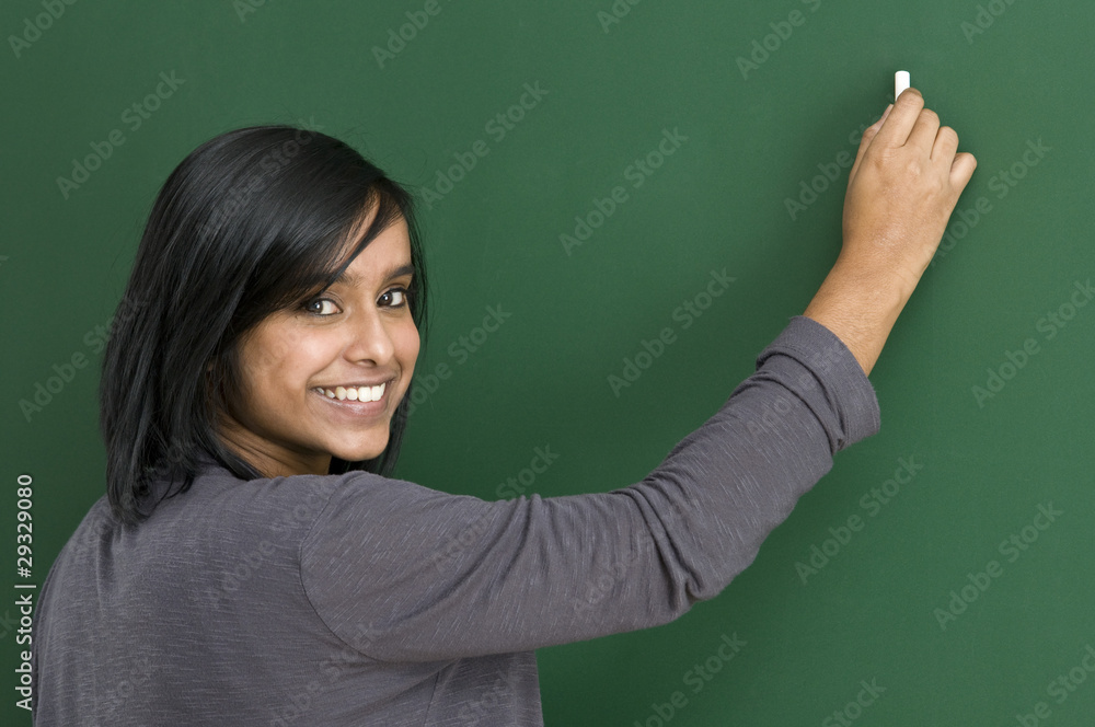 smiling teacher at blackboard