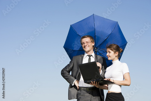 Businessman with laptop and girl on the street, summer day