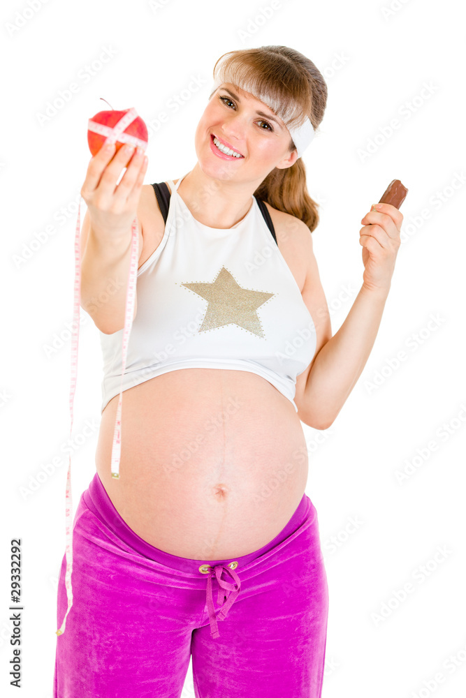 Apple or chocolate? Pregnant woman choosing healthy lifestyle Apple or chocolate? Pregnant woman choosing healthy lifestyle