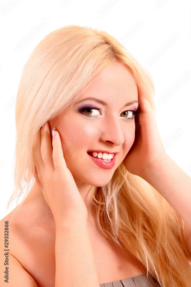 Young beautiful smiling blond woman touching her face isolated o Young beautiful smiling blond woman touching her face isolated o