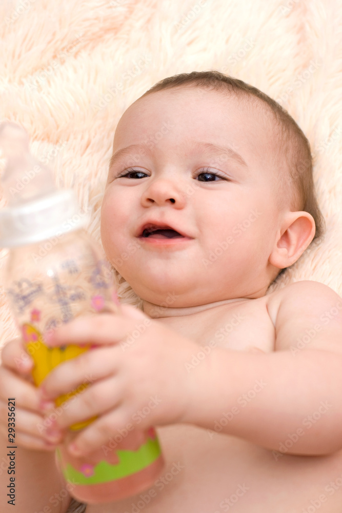 Little caucasian boy drinking from the bottle Little caucasian boy drinking from the bottle