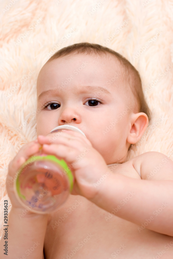 Little caucasian boy drinking from the bottle Little caucasian boy drinking from the bottle