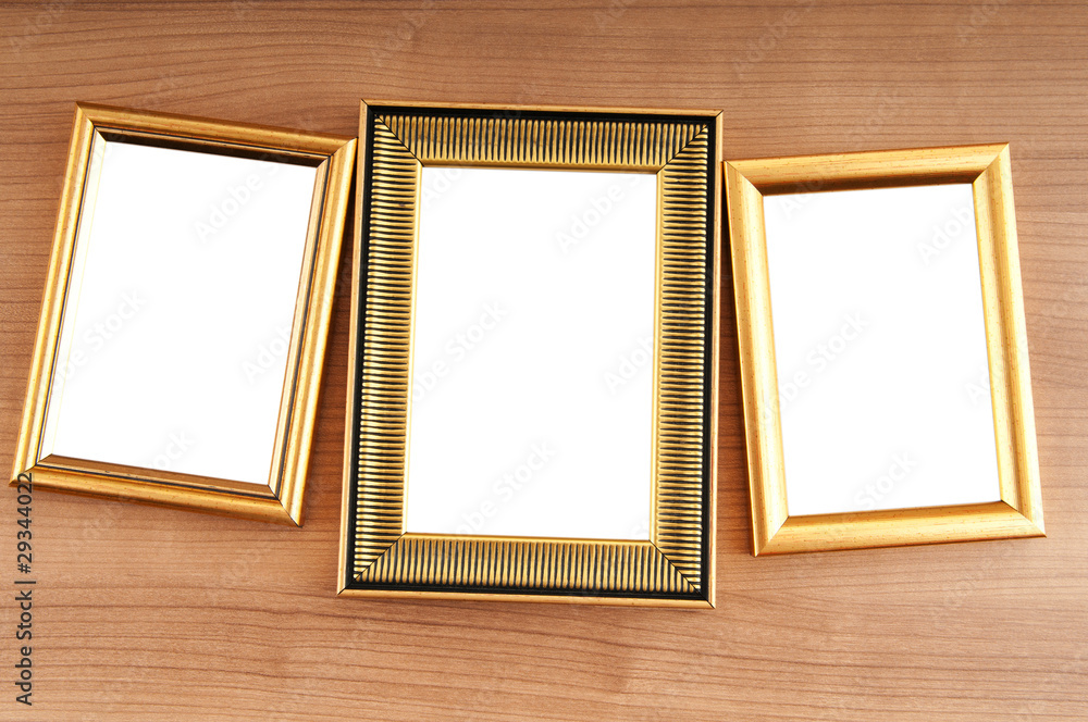 Picture frames on the polished wooden background Picture frames on the polished wooden background